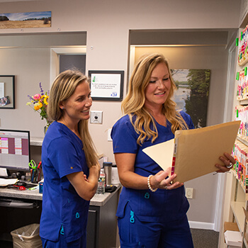 A Hanover dental team member holding a patient file